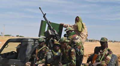 Nigerien soldiers patrol outside the Diffa airport in South-East Niger, near the Nigerian border, on December 23, 2020. - Under the constant threat of the Islamists of Boko Haram and its dissidents, Diffa, the large city in southeastern Niger on the border with Nigeria, lives under siege with frightened and economically strapped inhabitants. (Photo by Issouf SANOGO / AFP)